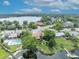 Lakefront home featuring a well-kept lawn, mature trees, and easy access to recreational activities at 1329 Maury Rd, Orlando, FL 32804