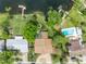 Aerial view of the property showcasing the house, lush backyard, private pool, and waterfront location at 1329 Maury Rd, Orlando, FL 32804