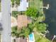 Aerial view highlighting the house with its backyard and waterfront location along with a community pool at 1329 Maury Rd, Orlando, FL 32804
