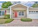 Welcoming entrance with red door, brick pathway, white columns and well-kept hedges at 1329 Maury Rd, Orlando, FL 32804