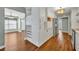 Open kitchen with white cabinetry, wine rack, stainless steel appliances and hardwood flooring at 1329 Maury Rd, Orlando, FL 32804