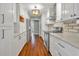Updated kitchen with white cabinets, stainless steel appliances, stylish backsplash, and modern lighting at 1329 Maury Rd, Orlando, FL 32804