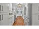Modern kitchen with white cabinetry, stainless steel appliances, and wood floors at 1329 Maury Rd, Orlando, FL 32804