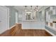 Modern kitchen features white cabinetry and wood flooring at 1329 Maury Rd, Orlando, FL 32804