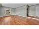 Clean living room boasts hardwood floors, neutral walls, and a large window for lots of light at 1329 Maury Rd, Orlando, FL 32804