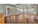 Open living space featuring hardwood floors, windows, and access to the screened porch at 1329 Maury Rd, Orlando, FL 32804