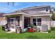Backyard featuring a screened-in porch, a grill, and well-maintained landscaping at 1423 Marsh Meadow Ln, Davenport, FL 33896