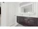 Modern bathroom featuring a double sink vanity with LED-lit mirror at 1423 Marsh Meadow Ln, Davenport, FL 33896