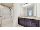 Bathroom featuring a double vanity, shower, and tiled floors at 1423 Marsh Meadow Ln, Davenport, FL 33896