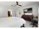 Spacious bedroom with walk-in closet, en-suite bathroom, ceiling fan, and TV at 1423 Marsh Meadow Ln, Davenport, FL 33896