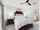 Comfortable bedroom features plush carpet, ceiling fan, and adjoining bathroom at 1423 Marsh Meadow Ln, Davenport, FL 33896