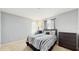 Bedroom with neutral walls, carpet, and stylish black and white bedding at 1423 Marsh Meadow Ln, Davenport, FL 33896