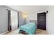 Bedroom with large window, a soft blue comforter and sleek gray bookcase at 1423 Marsh Meadow Ln, Davenport, FL 33896