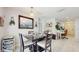 Cozy dining area featuring a dark wood table, seating for four, and a stylish bar area at 1423 Marsh Meadow Ln, Davenport, FL 33896