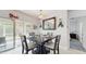 Inviting dining area features a dark wood table, seating for four, and sliding glass doors to the patio at 1423 Marsh Meadow Ln, Davenport, FL 33896