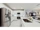 Bright kitchen with white cabinets, stainless steel appliances, and a central island with seating at 1423 Marsh Meadow Ln, Davenport, FL 33896