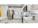 Well-lit kitchen featuring white cabinets, modern appliances, and a light-colored countertop at 1423 Marsh Meadow Ln, Davenport, FL 33896
