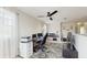 Well-lit home office space with a ceiling fan, desk, and carpet at 1423 Marsh Meadow Ln, Davenport, FL 33896