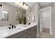 Modern bathroom with double vanity, matte black fixtures, and a large mirror at 15319 Soaring Bluff Dr, Montverde, FL 34756