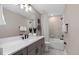 Modern bathroom features a gray vanity, bright lighting, and a shower over tub with neutral tiling at 15319 Soaring Bluff Dr, Montverde, FL 34756