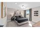 Cozy bedroom with neutral decor, decorative lamps, a large window, and comfortable bed at 15319 Soaring Bluff Dr, Montverde, FL 34756