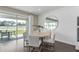 Bright dining area with sliding glass doors, modern table, and stylish decor at 15319 Soaring Bluff Dr, Montverde, FL 34756