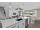 Bright kitchen featuring a center island with sink, pendant lighting and backyard view at 15319 Soaring Bluff Dr, Montverde, FL 34756