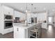 Modern kitchen featuring a large island, pendant lighting and stainless steel appliances at 15319 Soaring Bluff Dr, Montverde, FL 34756