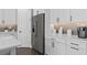 Bright kitchen featuring white cabinets, a gray backsplash, and stainless steel appliances at 15319 Soaring Bluff Dr, Montverde, FL 34756
