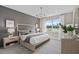 Serene main bedroom with elegant chandelier, neutral tones, and ample natural light at 15319 Soaring Bluff Dr, Montverde, FL 34756