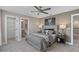 A serene bedroom featuring a comfortable bed and access to an ensuite bathroom at 15319 Soaring Bluff Dr, Montverde, FL 34756