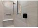 Sleek walk-in shower with built-in bench, niche, and modern tile design at 15319 Soaring Bluff Dr, Montverde, FL 34756