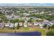 Expansive aerial view of a residential neighborhood with tree-lined streets, waterfront properties, and lush greenery at 1556 Sherbourne St, Winter Garden, FL 34787