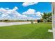 Beautiful backyard featuring a serene pond surrounded by a lush green lawn at 1556 Sherbourne St, Winter Garden, FL 34787