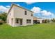 A spacious backyard featuring a well-maintained lawn and a neutral-colored two-story home at 1556 Sherbourne St, Winter Garden, FL 34787