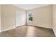 Bedroom with new flooring, closet with bifold doors, and window at 1556 Sherbourne St, Winter Garden, FL 34787
