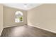 Bedroom with new laminate flooring, base trim, and a bright window at 1556 Sherbourne St, Winter Garden, FL 34787