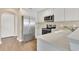 Bright kitchen features stainless steel appliances, white cabinets, and laminate flooring at 1556 Sherbourne St, Winter Garden, FL 34787