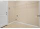 A modest laundry room featuring tile flooring, a wire shelf, and utility hookups at 1556 Sherbourne St, Winter Garden, FL 34787