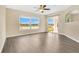 Spacious living room featuring new flooring, fan, backyard and water view at 1556 Sherbourne St, Winter Garden, FL 34787