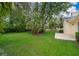 Expansive backyard featuring lush green grass and mature trees, perfect for outdoor activities and relaxation at 1709 Iverness Ct, Longwood, FL 32779