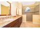 Bathroom featuring double sinks, granite countertops, and a glass-enclosed tiled shower at 1709 Iverness Ct, Longwood, FL 32779
