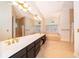 Bright bathroom featuring a double sink vanity, soaking tub, and separate tiled shower at 1709 Iverness Ct, Longwood, FL 32779