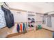 Walk-in closet offering ample storage space with built-in shelving and multiple hanging rods at 1709 Iverness Ct, Longwood, FL 32779