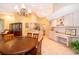 Open dining area adjacent to kitchen features hardwood table set and lovely chandelier lighting at 1709 Iverness Ct, Longwood, FL 32779