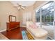 Bright and airy main bedroom seating area with a chaise lounge and access to the pool at 1709 Iverness Ct, Longwood, FL 32779