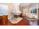Main bedroom seating area with a modern fireplace and hardwood flooring at 1709 Iverness Ct, Longwood, FL 32779
