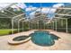 A screened-in pool area with a luxurious pool and hot tub, enveloped in lush greenery at 1709 Iverness Ct, Longwood, FL 32779