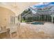 A screened-in pool area with a luxurious pool, tile flooring, and comfortable outdoor seating at 1709 Iverness Ct, Longwood, FL 32779