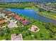 Aerial view of community with a pond, playground, green space, and beautiful lawns at 1712 Boat Launch Rd, Kissimmee, FL 34746